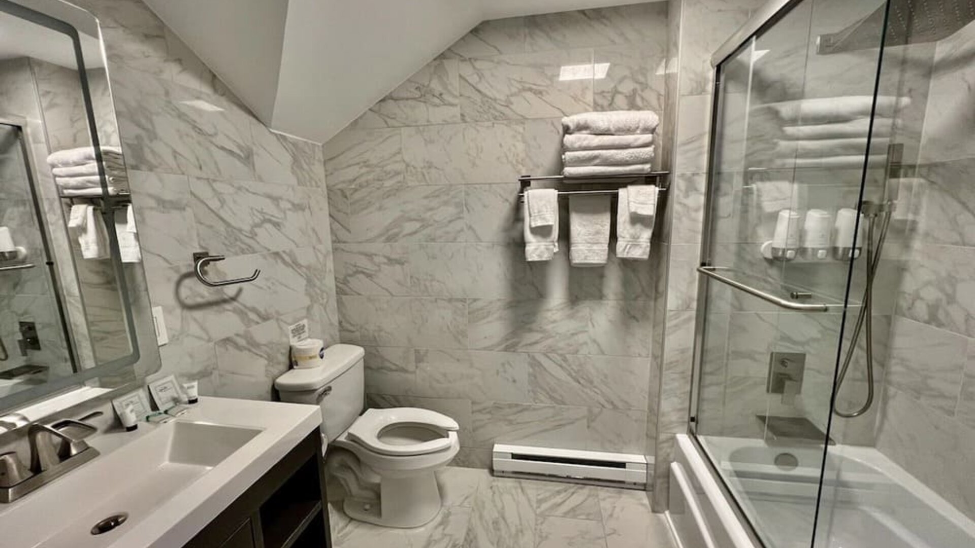 Spacious guest bathroom with shower at Skylaranna Hotel and Resort.