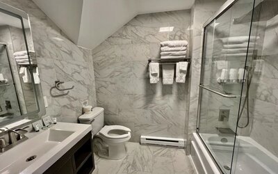 Spacious guest bathroom with shower at Skylaranna Hotel and Resort.
