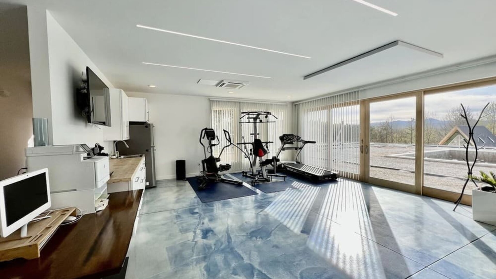 Fitness center with treadmill and weights at Skylaranna Hotel and Resort.