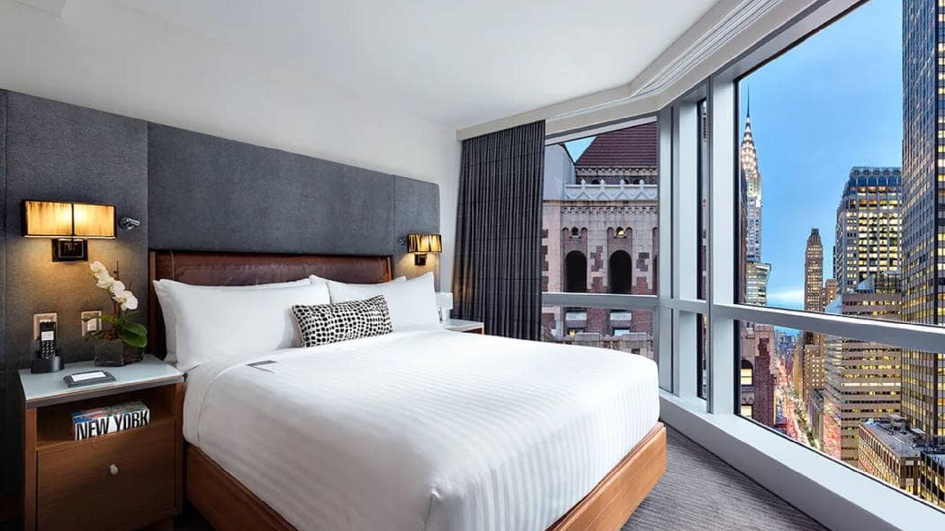 Hotel 48LEX New York guest room with double bed and stunning city view.