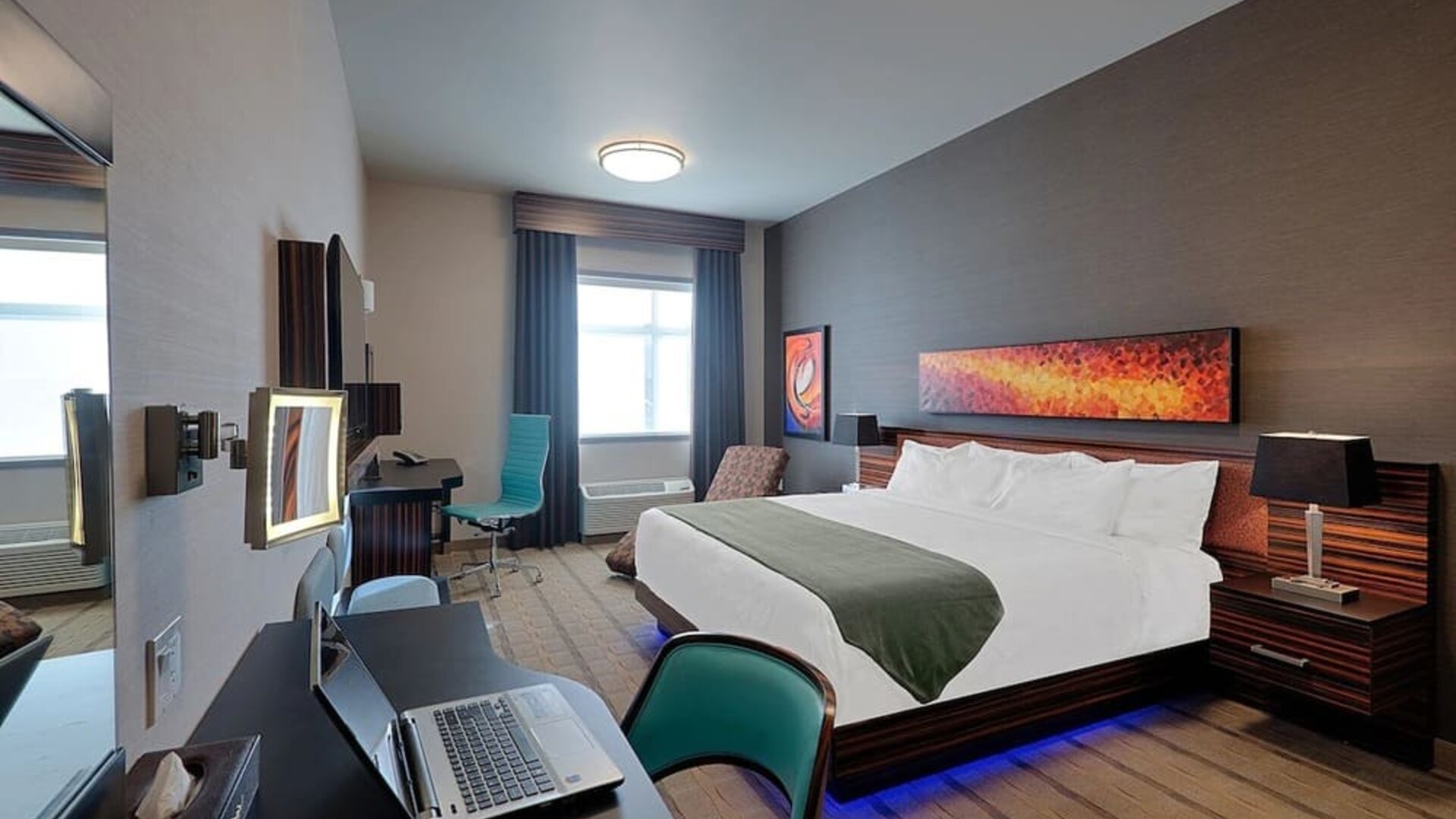 Comfortable king room with work desk and TV at Hotel Clique Calgary Airport.
