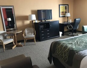 Work desk, TV, table and chairs inside day use room at Travelodge Absecon Atlantic City.