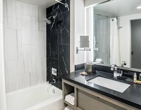 Private guest bathroom with shower and tub at DoubleTree By Hilton Washington DC North/Gaithersburg.
