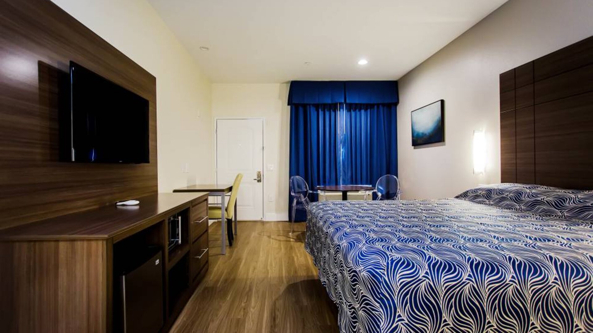 Day use room with dining table, work desk and TV at Palace Inn Blue Gessner.