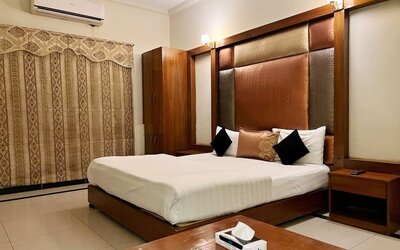 King bedroom with air conditioning at The Grand Hotel Multan.