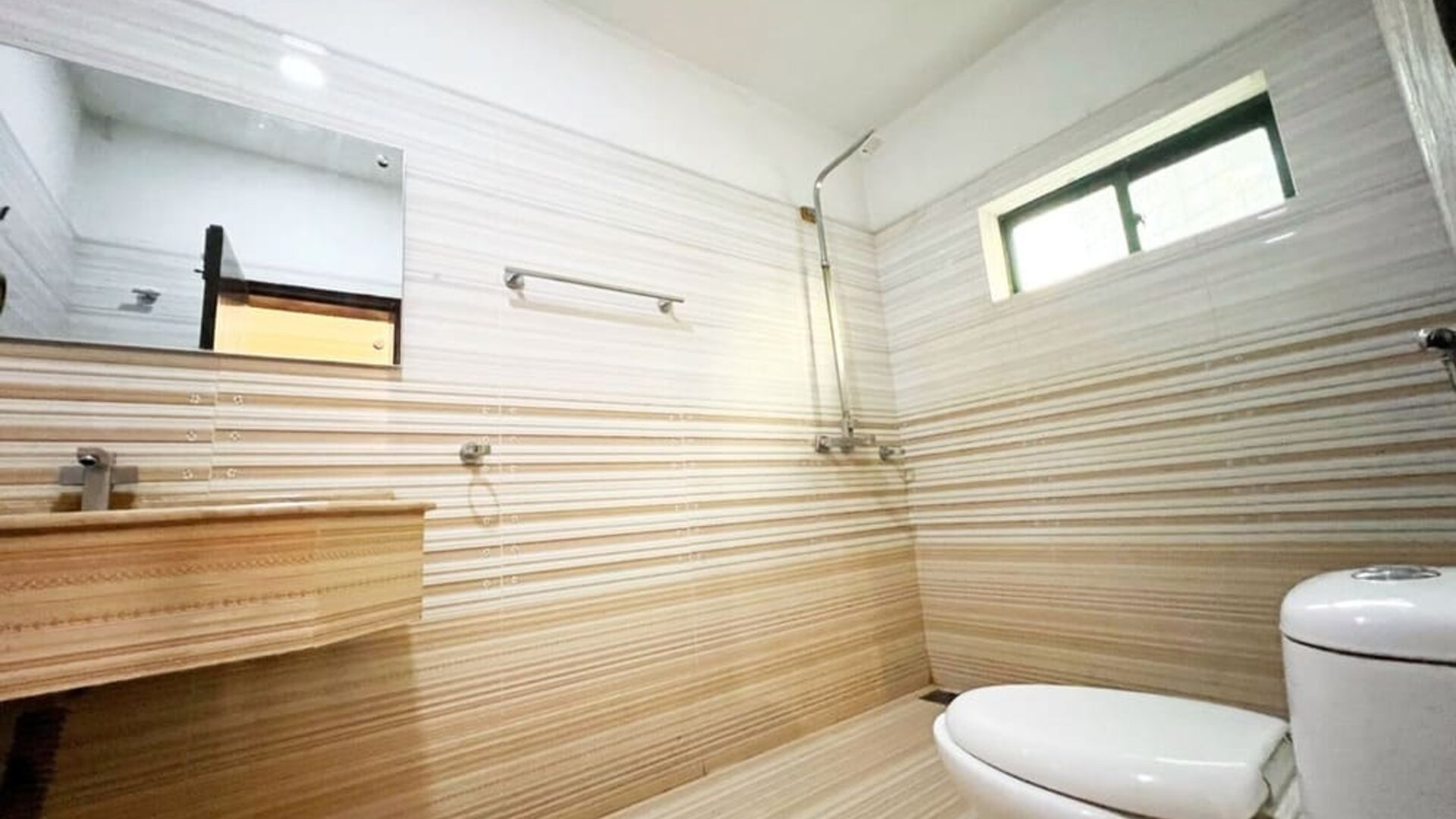 Private guest bathroom with shower at The Grand Hotel Multan.