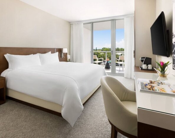 Spacious king bedroom with work desk at The Altair Hotel Bay Harbor.