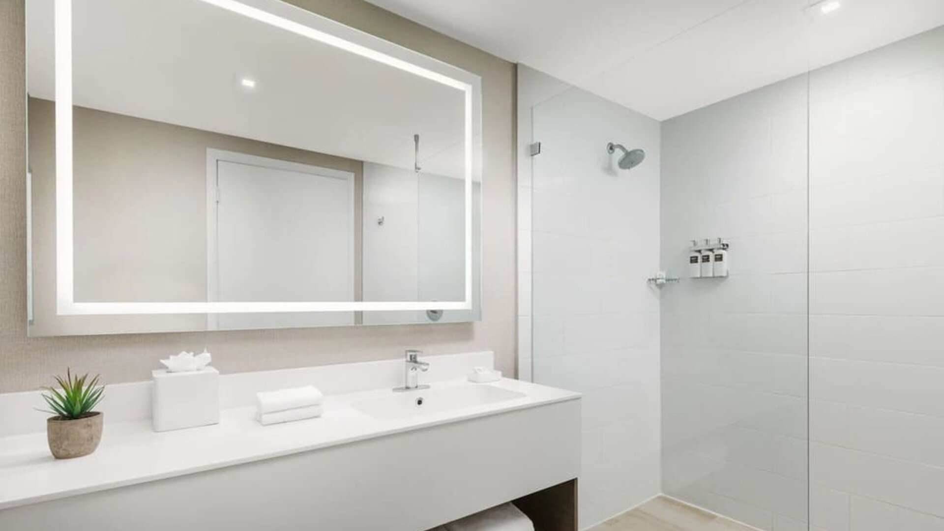 Private guest bathroom with shower at The Altair Hotel Bay Harbor.