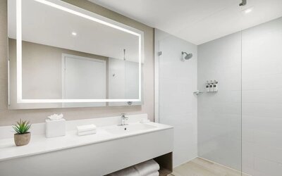 Private guest bathroom with shower at The Altair Hotel Bay Harbor.