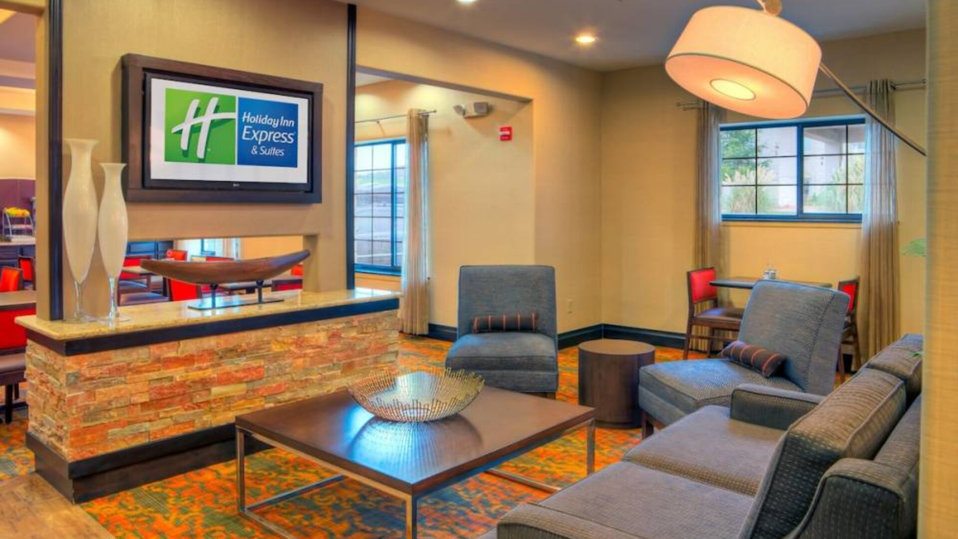 Lobby and coworking lounge at Holiday Inn Express Granbury.