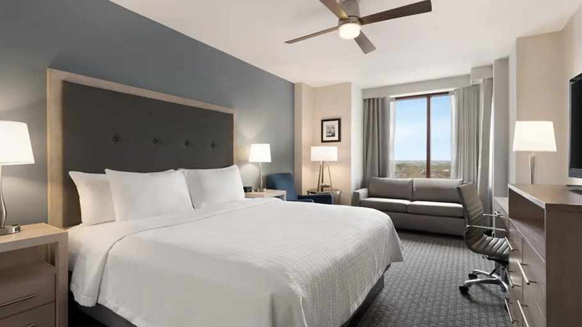 Day use room with work desk and sofa at Homewood Suites by Hilton University City.