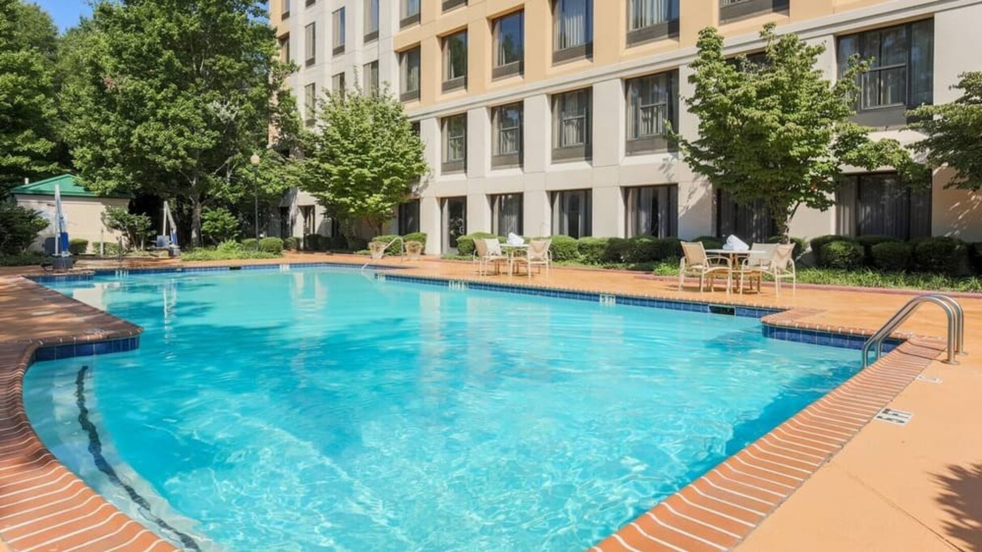Stunning outdoor pool with seating area at DoubleTree Atlanta Airport.
