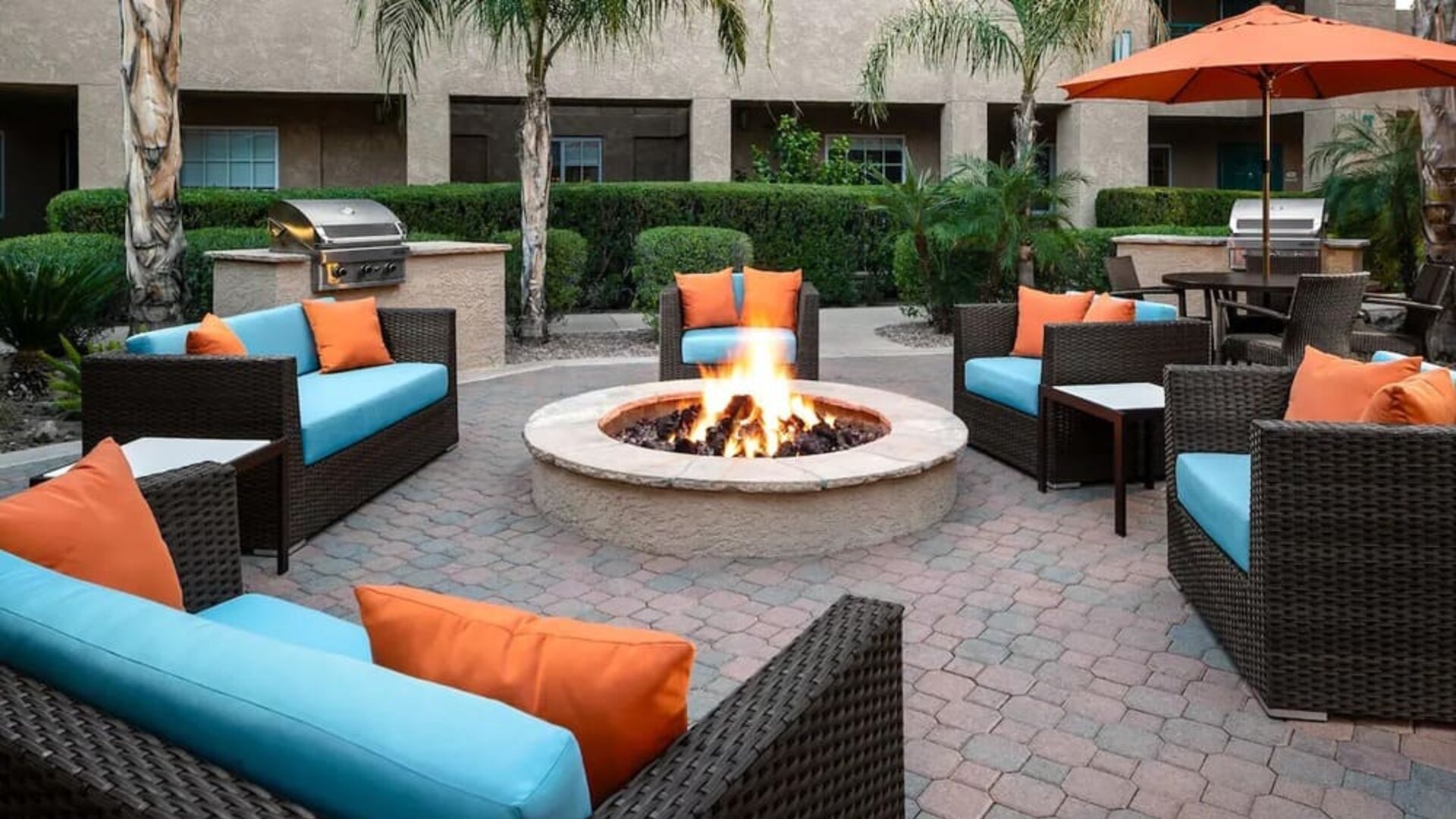 Outdoor lounge and coworking space with fire pit at Hyatt House Scottsdale.