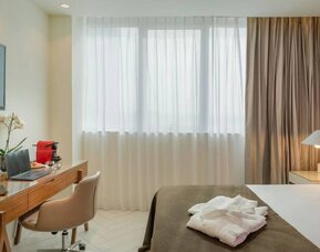 Day room with a guest bed and work desk and chair.