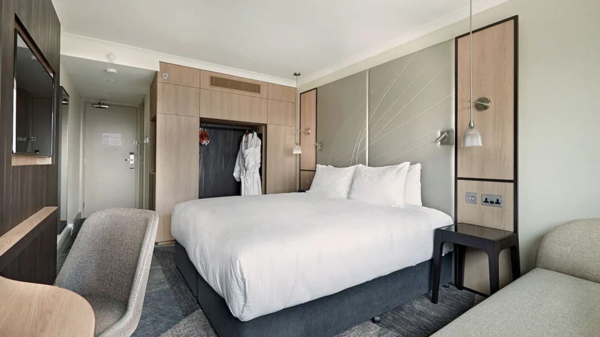 Delux king room with TV and desk at Hyatt Place London Heathrow Airport.