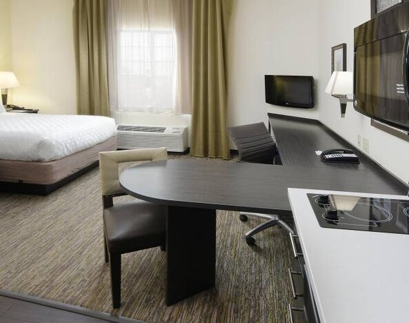 Day use room with work desk and kitchen at Candlewood Suites Odessa.