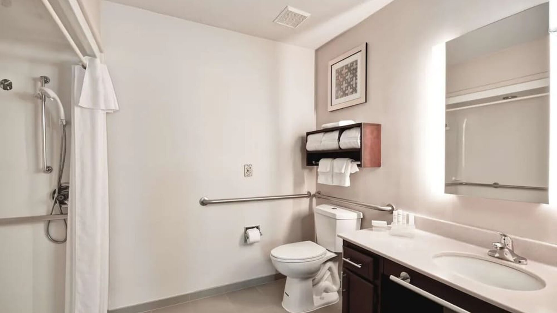 Private guest bathroom with shower at Homewood Suites By Hilton Dallas-Lewisville.