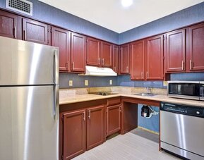 Day room equipped with kitchen, refrigerator, and microwave at Homewood Suites By Hilton Dallas-Lewisville.