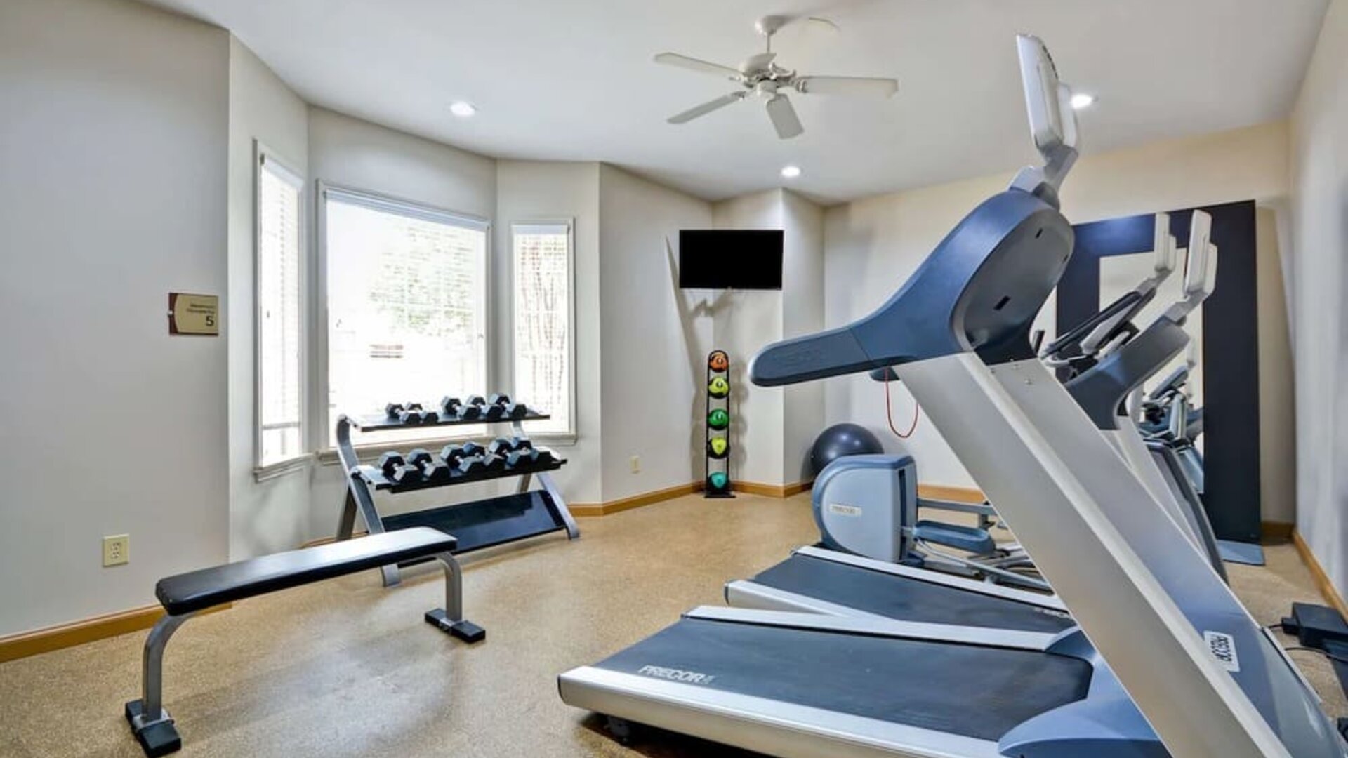 Well equipped fitness center at Homewood Suites By Hilton Dallas-Lewisville.