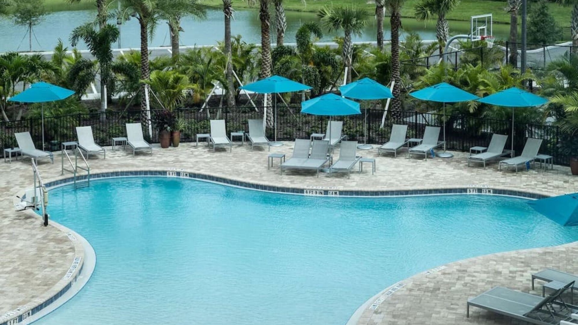 Relaxing pool area with pool chairs at Hampton Inn & Suites Cape Canaveral Cruise Port.