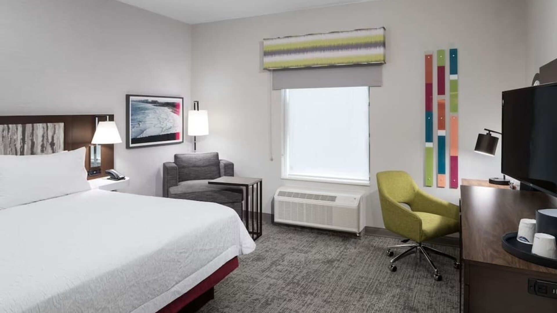 King bed with natural light at Hampton Inn & Suites Cape Canaveral Cruise Port.