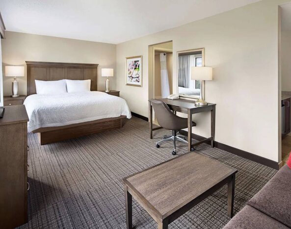 Day use room with work desk and sofa at Hampton Inn & Suites Alexandria.
