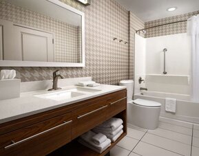 Guest bathroom with shower and bath at Home2 Suites By Hilton Charleston Airport/Convention Center.