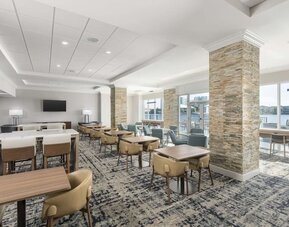 Lobby and coworking lounge at Homewood Suites By Hilton Miami Airport-Blue Lagoon.