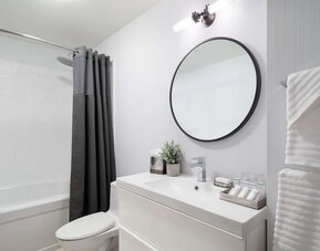 Guest bathroom with shower and bath at Hilton Garden Inn New York/Tribeca.