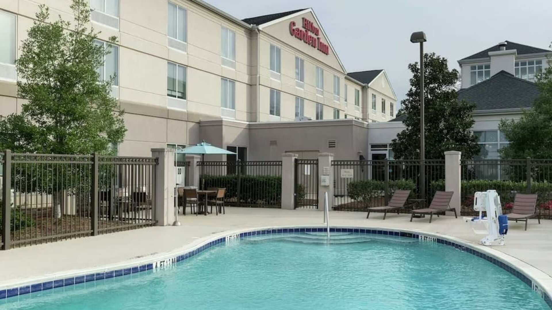 Stunning outdoor pool with pool chairs at Hilton Garden Inn Dothan.