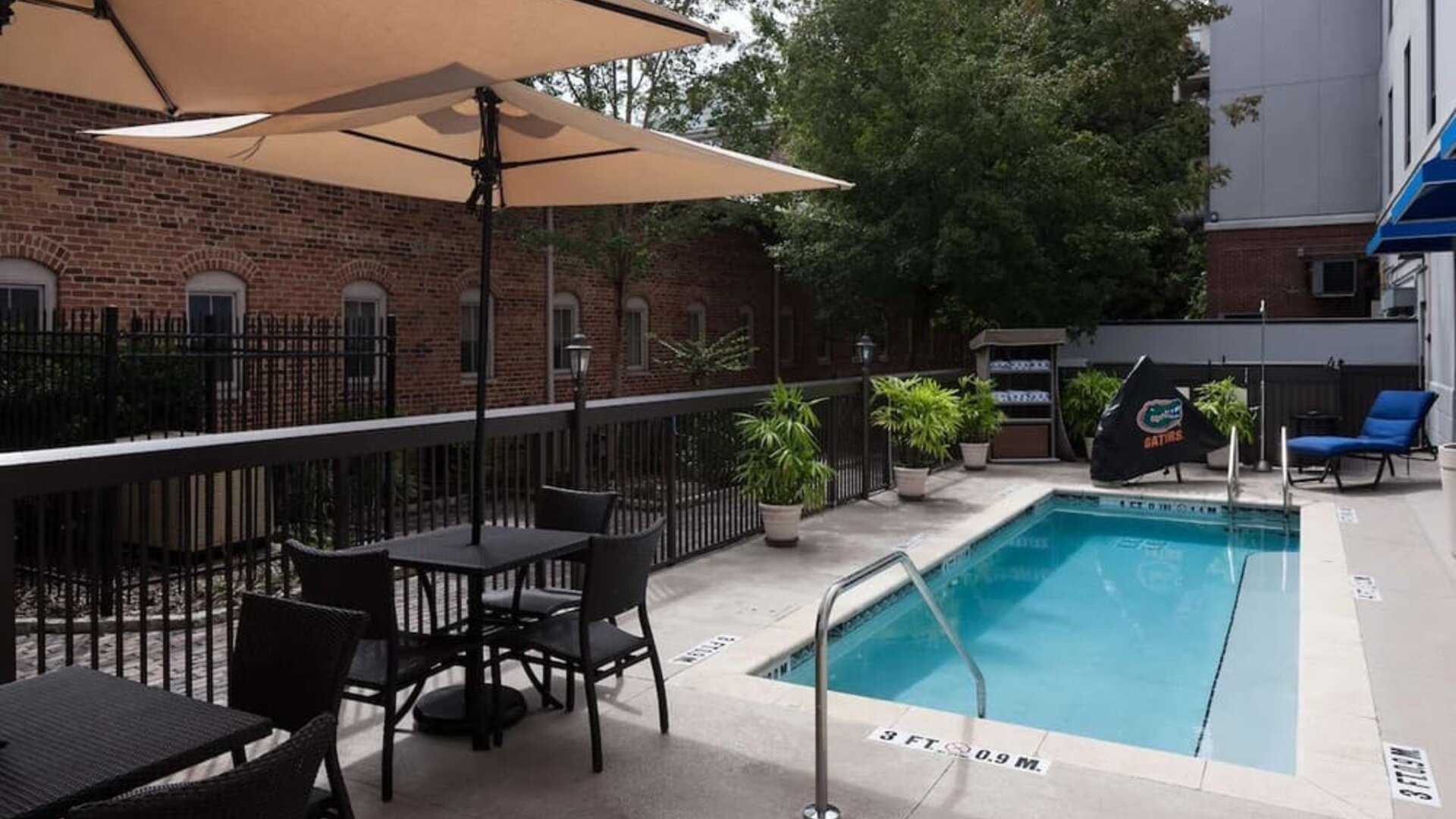 Outdoor pool with seating area at Hampton Inn & Suites Gainesville-Downtown.