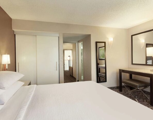 King bed with work space at Embassy Suites By Hilton Arcadia Pasadena Area.