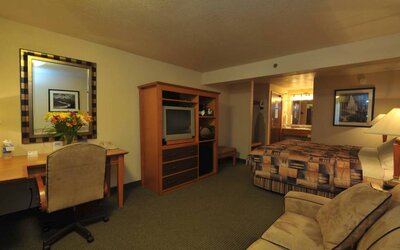 Day use room with work desk and sofa at Shilo Inn Rose Garden.

