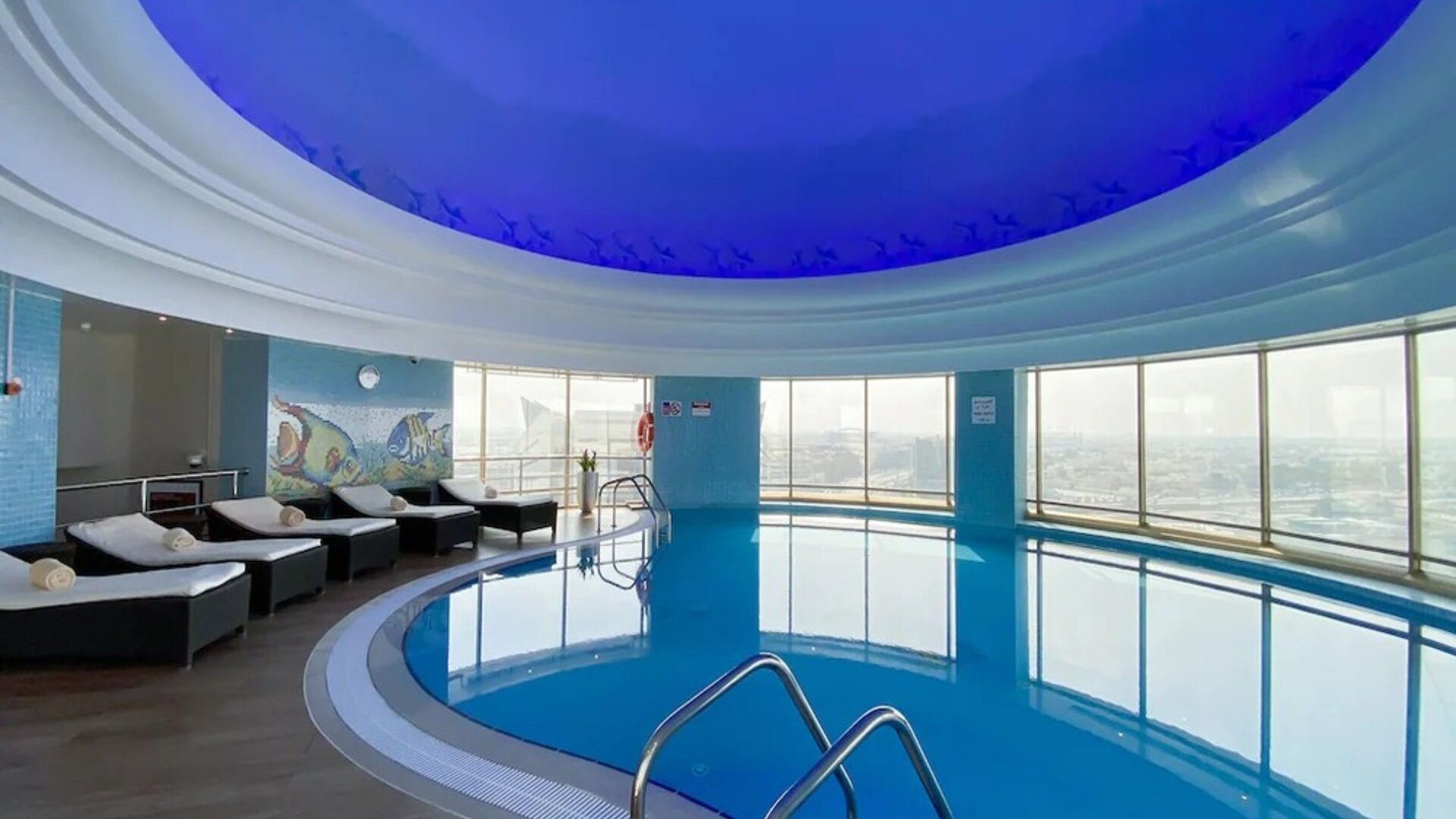 Relaxing indoor pool and pool area at Millennium Hotel Doha.
