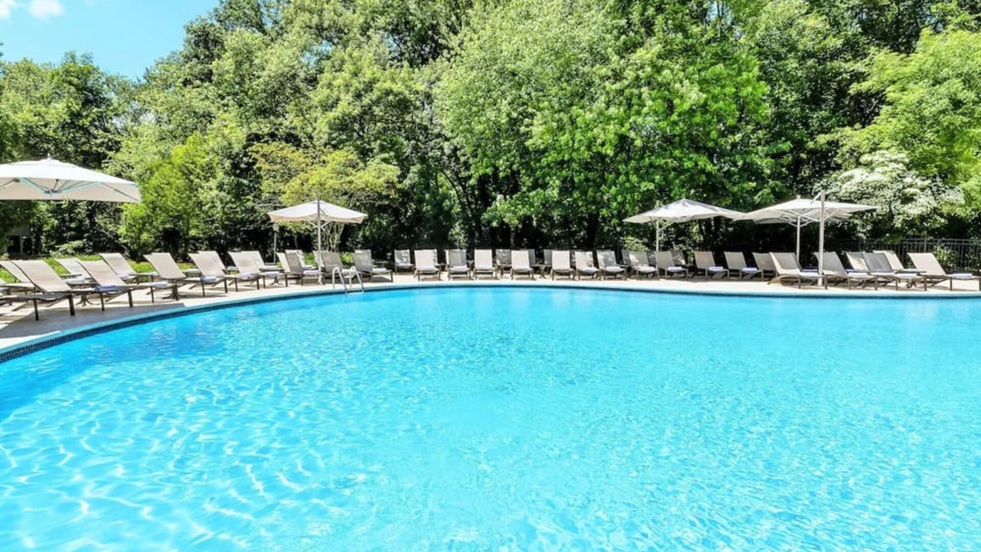Luxurious outdoor pool with pool chairs at Hilton Short Hills.