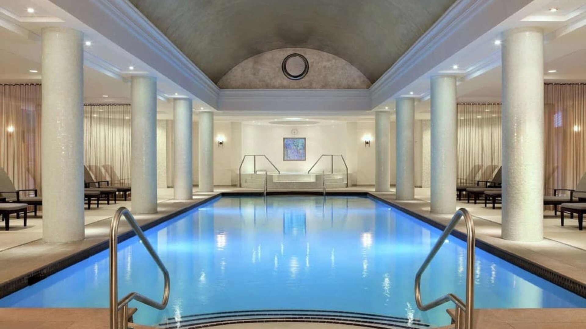 Stunning indoor pool with pool chairs at Hilton Short Hills.