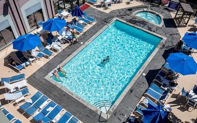 Relaxing pool area with pool chairs at Hilton Whistler Resort & Spa.