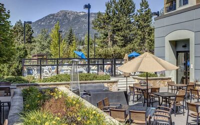 Outdoor terrace set in a lovely garden at Hilton Whistler Resort & Spa.