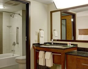 Guest bathroom with shower and tub at Hyatt Place Fort Lauderdale Cruise Port.