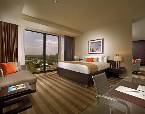 Day use room with work desk and sofa at EB Hotel Miami.