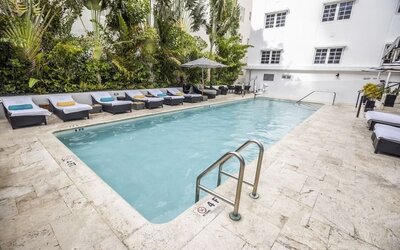 Relaxing pool area with sun loungers at Hotel Croydon.