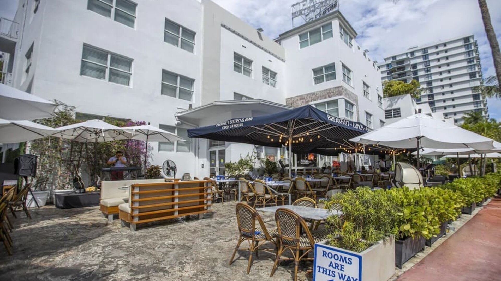 Comfortable outdoor tables and chairs with umbrellas ideal for coworking at Catalina Hotel & Beach Club.