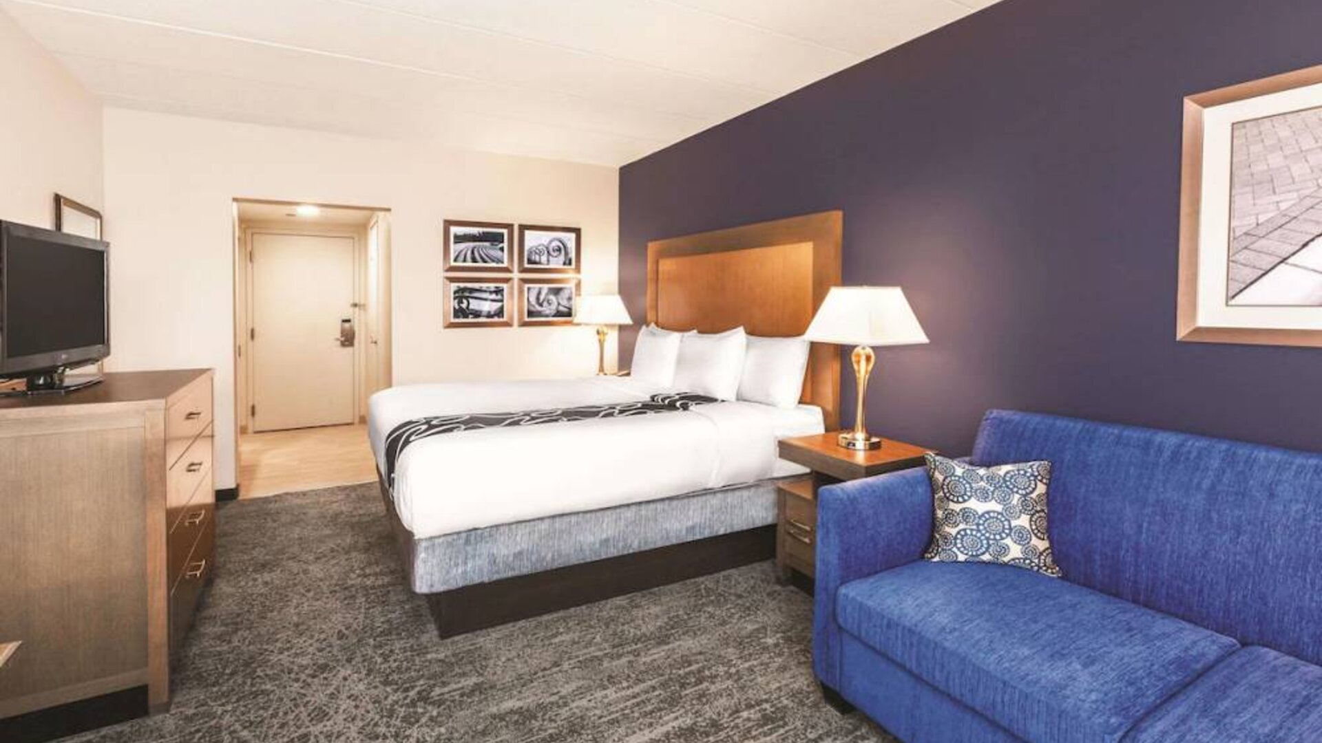 Day use room with TV and sofa at La Quinta Inn & Suites By Wyndham Philadelphia Airport.