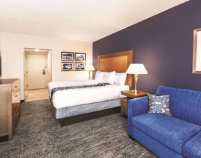 Day use room with TV and sofa at La Quinta Inn & Suites By Wyndham Philadelphia Airport.