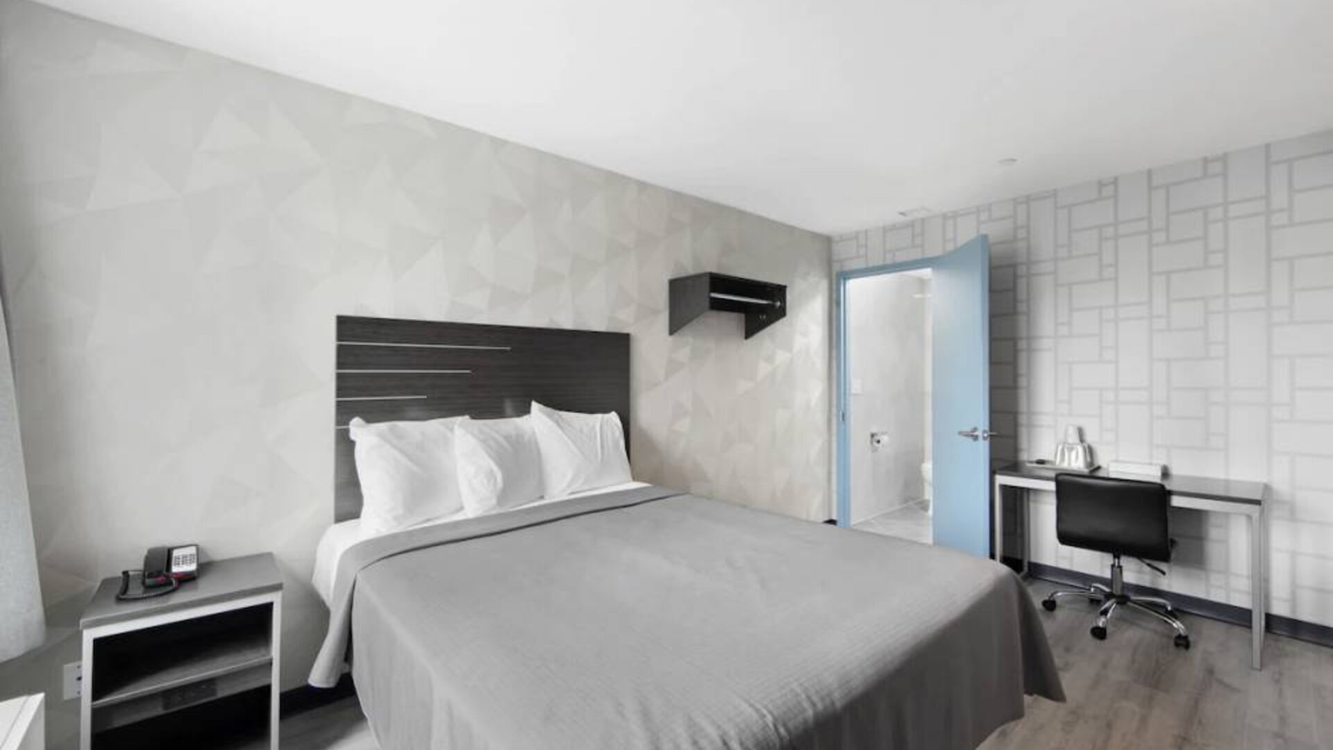 Day use room with work desk and natural light at Hotel 365 Bronx.