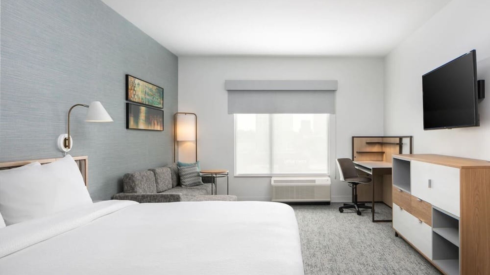 Bright-lit day use room with work desk and sofa at TownePlace Suites Nashville Midtown.