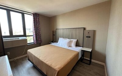 King room with natural light at Regal Inn & Suites New York.