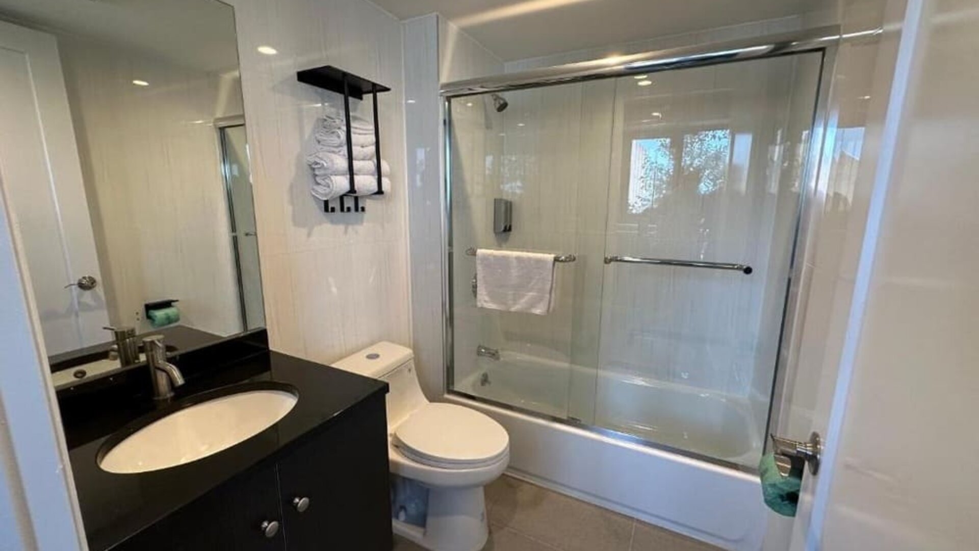 Guest bathroom with shower at Regal Inn & Suites New York.