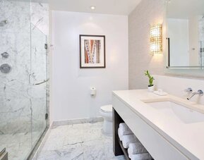 Bathroom with shower at Ko'a Kea Resort On Po`ipu Beach.