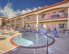 Relaxing pool area with loungers at Casa Rosa Inn.